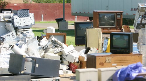 Workers loading mixed waste from a shopfront into a vehicle